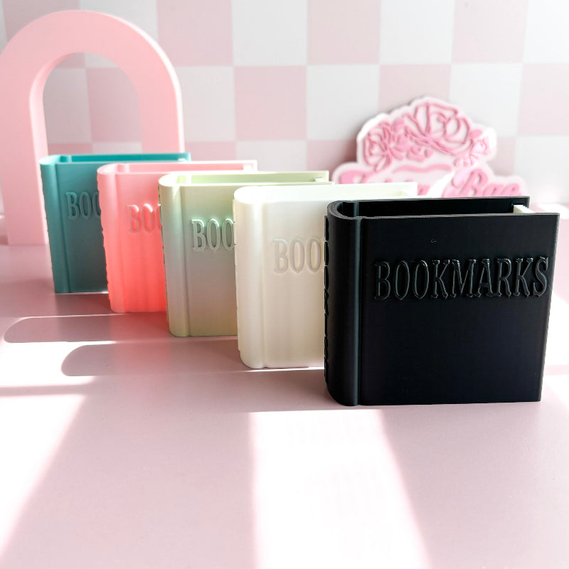 Set of colorful bookmark holders with 'BOOKMARKS' text on a pink background