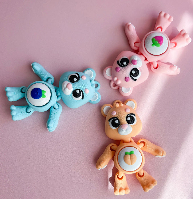 Three colorful animal-shaped clips on a pink background