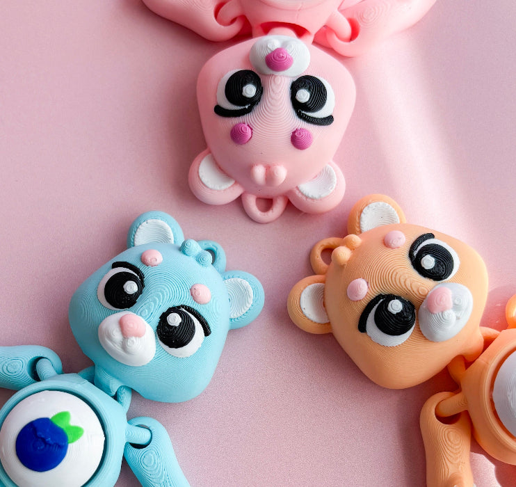 Three colorful animal-themed airpods cases on a pink background