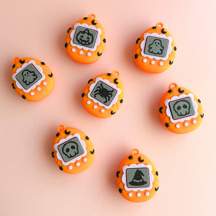 Orange digital pendants with ghost designs on a beige background