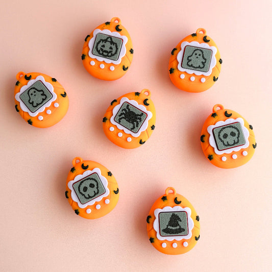 Orange digital pendants with ghost designs on a beige background