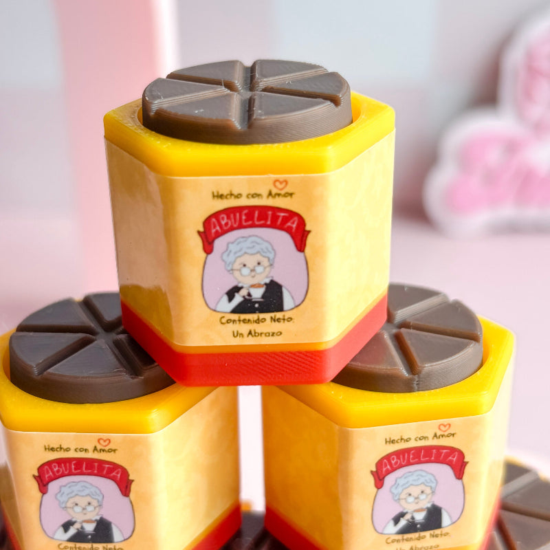 Yellow containers with chocolate mold on a pink background