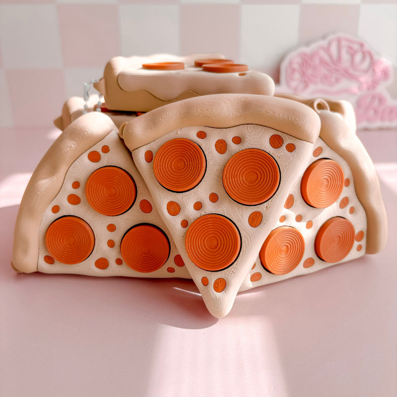 Fidget Clicker designed like a pizza with slices on a pink background