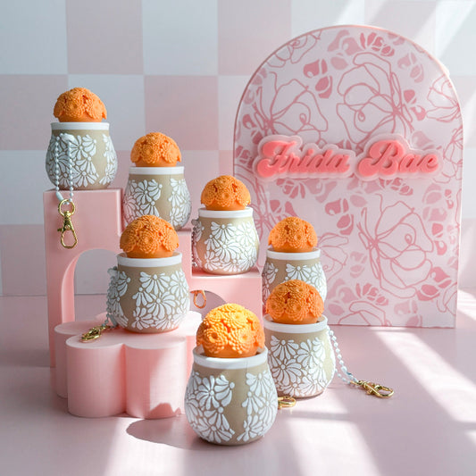 Decorative items with floral patterns on a pink stand against a checkered background
