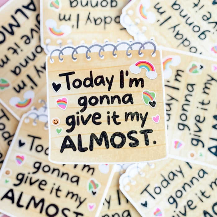 Motivational stickers with text 'Today I'm gonna give it my ALMOST' on a beige background.