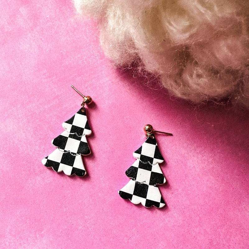 Ooze Christmas vibes with our "Checker Print Christmas Tassel Dangle Earrings." They  are handmade with precision, made from premium polymer clay with a funky checker print - perfect to elevate your holiday style!