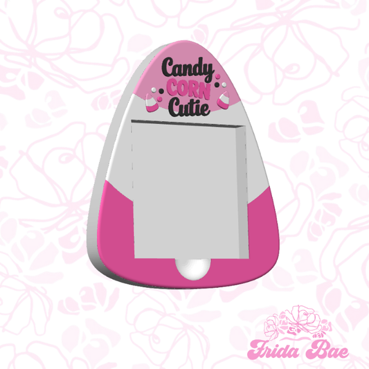 Pink and white candy corn-shaped cutter with 'Candy Corn Cutie' text 