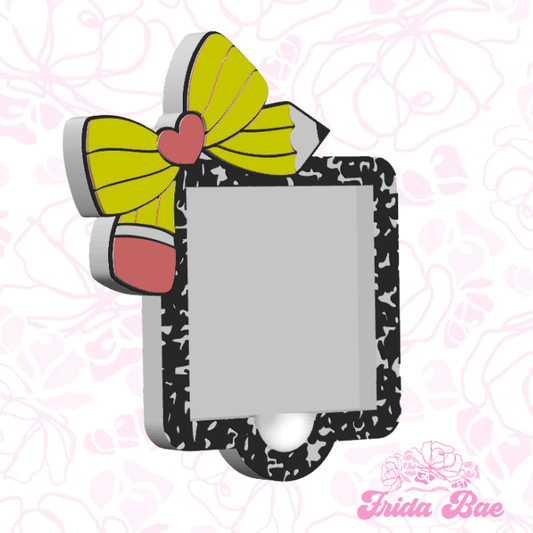Decorative photo frame with a pencil and bow design on a pink floral background, branded 'Frida Bae'.