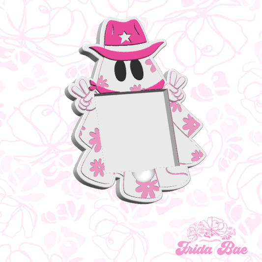 Cartoon ghost character with a pink hat and outfit on a pink floral background, branded 'Frida Bae'.
