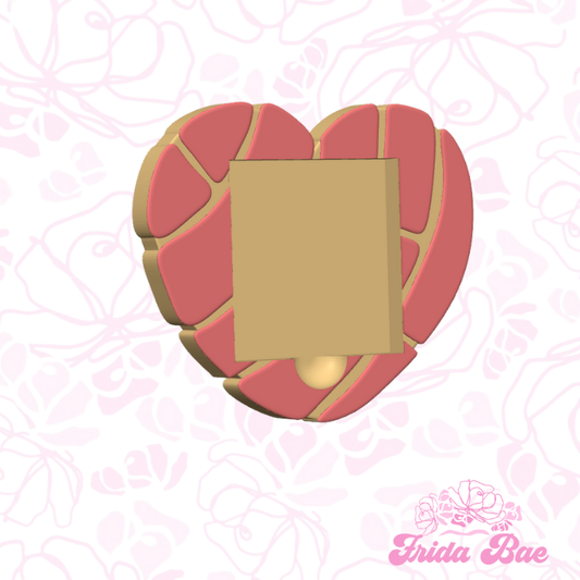 Heart-shaped gold plaque on a pink floral background with 'Frida Bae' branding.