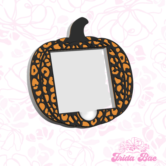 Pumpkin-shaped mirror with leopard print design on a pink floral background, branded 'frida Bae'.