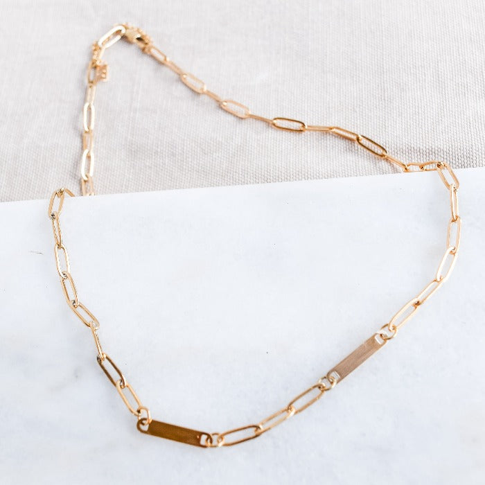 Elevate your style with our 2-Bar Paperclip Chain Necklace in gold. This fully customizable necklace features a sleek design and can be laser engraved in your choice of font. Make a statement and stand out from the crowd with this unique and personalized piece.