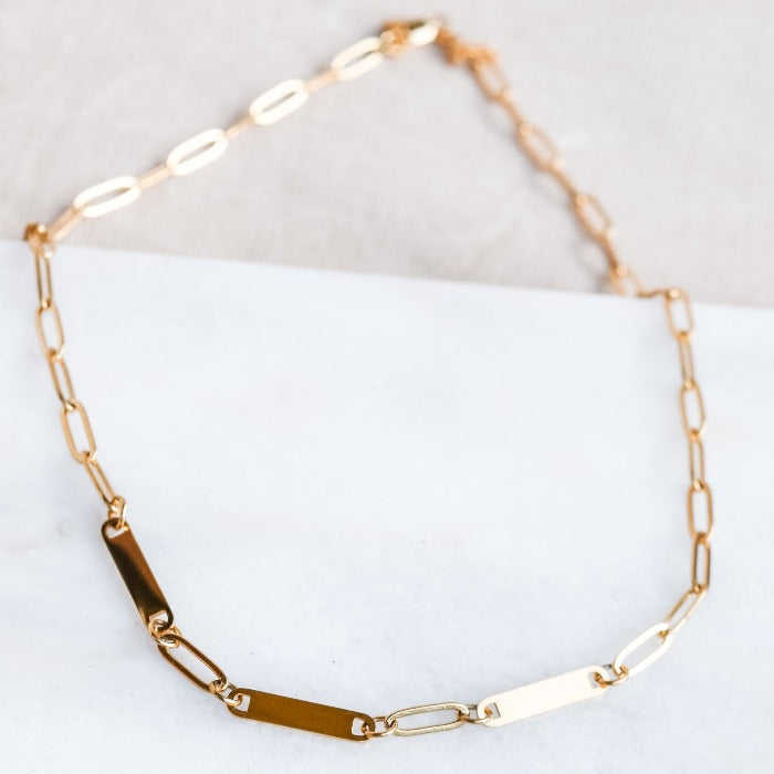 Elevate your style with our 3-Bar Paperclip Chain Necklace in gold. This fully customizable necklace features a sleek design and can be laser engraved in your choice of font. Make a statement and stand out from the crowd with this unique and personalized piece.