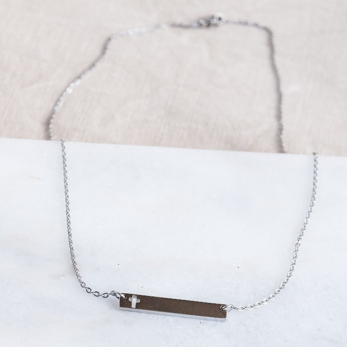 This polished gold necklace is the perfect accessory for any occasion! Featuring a beautifully engraved cross bar, it adds a touch of elegance and meaning to any outfit. Simple yet stunning, this necklace is a must-have in any jewelry collection