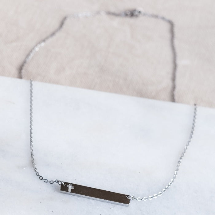 This polished gold necklace is the perfect accessory for any occasion! Featuring a beautifully engraved cross bar, it adds a touch of elegance and meaning to any outfit. Simple yet stunning, this necklace is a must-have in any jewelry collection