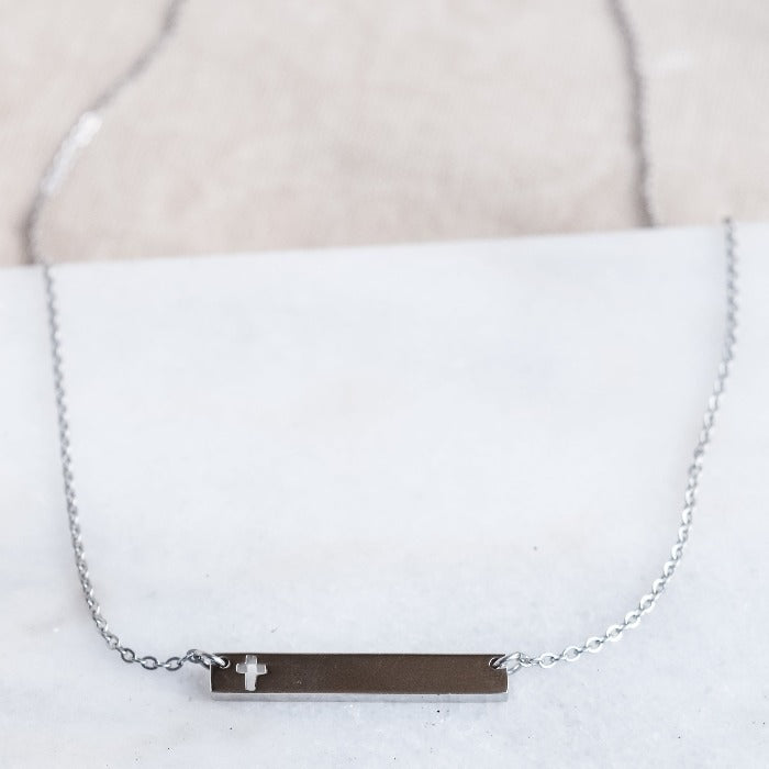 This polished gold necklace is the perfect accessory for any occasion! Featuring a beautifully engraved cross bar, it adds a touch of elegance and meaning to any outfit. Simple yet stunning, this necklace is a must-have in any jewelry collection