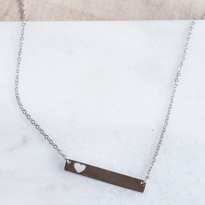 Show your love and dedication with our handcrafted heart bar necklace. The polished finish and 18" loop chain add a touch of elegance. Personalize with custom engraving for a heartfelt gift that will be treasured for years to come.