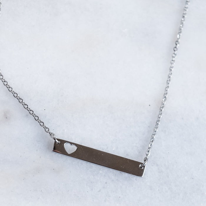 Show your love and dedication with our handcrafted heart bar necklace. The polished finish and 18" loop chain add a touch of elegance. Personalize with custom engraving for a heartfelt gift that will be treasured for years to come.