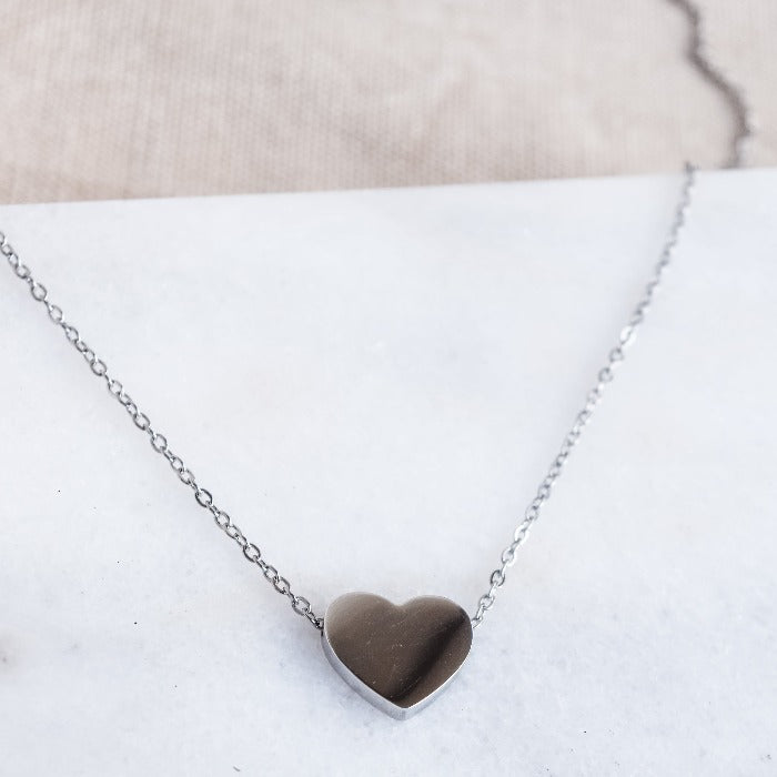The River Heart Necklace is the perfect accessory to show your love and devotion. With a smooth, polished finish and a charming heart-shaped design, this necklace is custom engraved to make it uniquely yours. Elevate any outfit and add a touch of romance to your look with this beautiful and heartfelt piece.