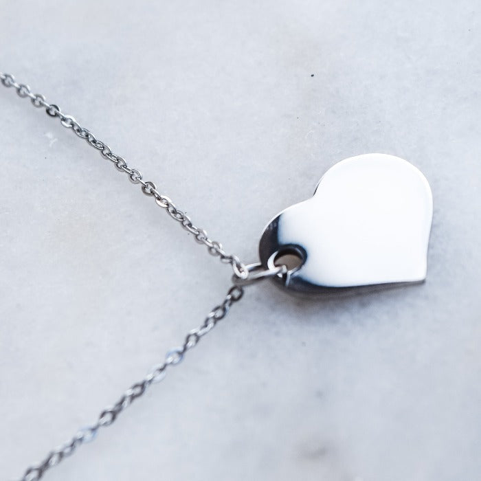 Express your love with the All My Corazon Necklace. Featuring a heart pendant and a stylish rollo chain, this customizable piece can be laser engraved in your preferred font. Make a statement and stand out with this one-of-a-kind and personalized necklace.