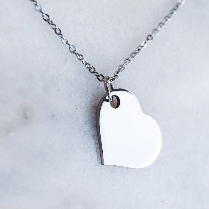 Express your love with the All My Corazon Necklace. Featuring a heart pendant and a stylish rollo chain, this customizable piece can be laser engraved in your preferred font. Make a statement and stand out with this one-of-a-kind and personalized necklace.