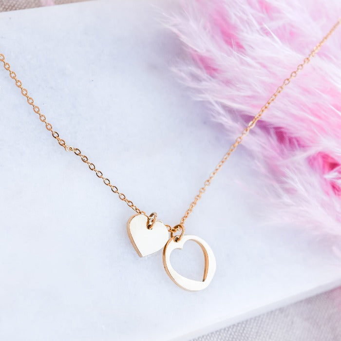 The PIECE OF MY HEART NECKLACE showcases a beautiful and unique design, featuring a heart-shaped cutout and charming metal charm. Perfectly paired with an 18" loop chain and 2" extender, this piece exudes timeless elegance. Show your love for life and fashion with this must-have accessory!