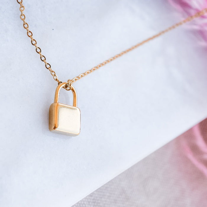 Unlock the key to your heart with our Locked in Love Loop Chain Necklace. Crafted with a gold lock on an 18" loopchain, this necklace symbolizes everlasting love. Personalize it with a custom engraving to make it truly one-of-a-kind. Express your passion and devotion with our necklace.