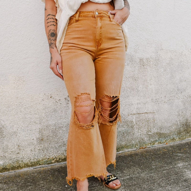 We love these vintage-styled jeans + their heavy distressing.  Features a wide-leg 90's style and a unique wash!  Pair with booties or some cute sandals!