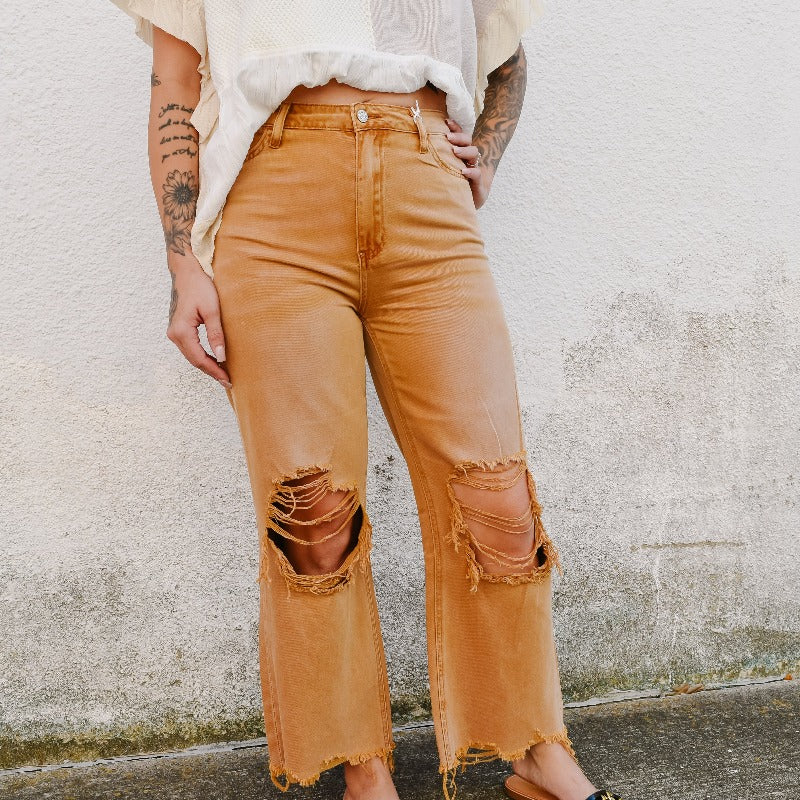 We love these vintage-styled jeans + their heavy distressing.  Features a wide-leg 90's style and a unique wash!  Pair with booties or some cute sandals!