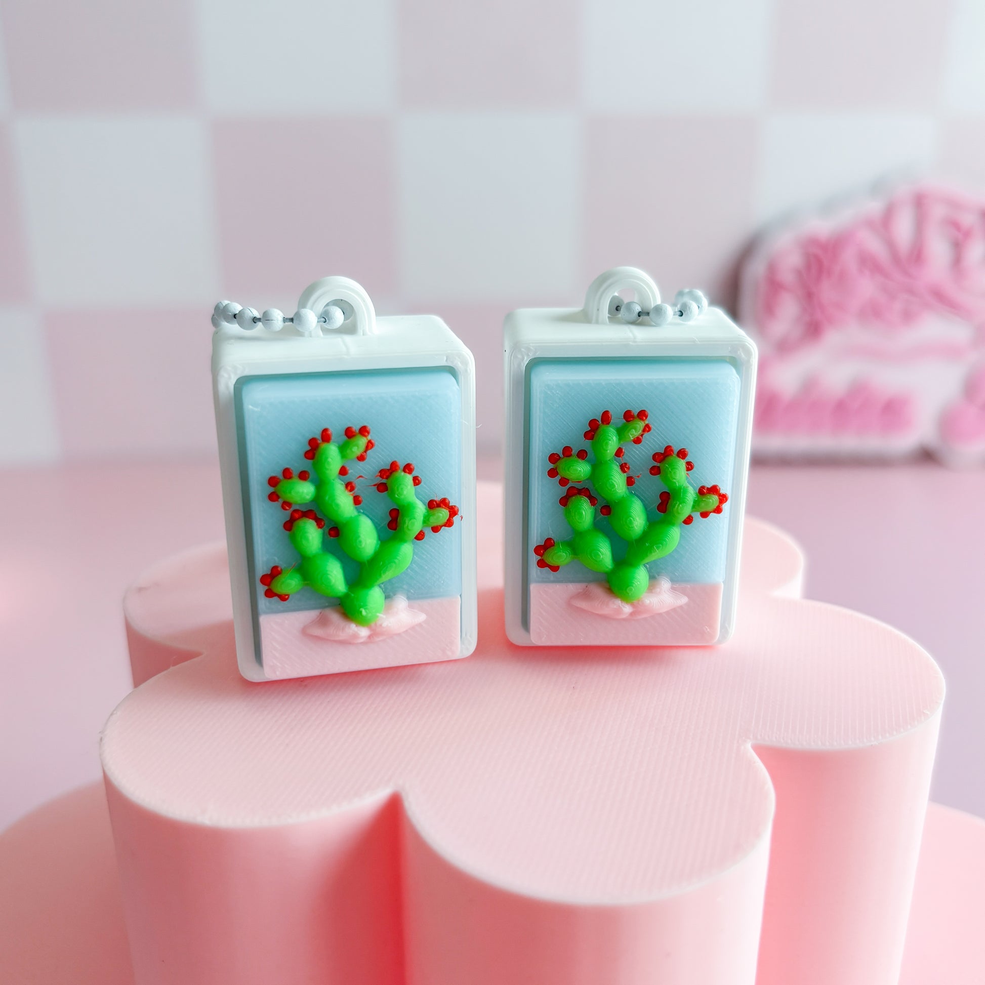 Merxican loteria fidget clicker with a cactus on a pink surface