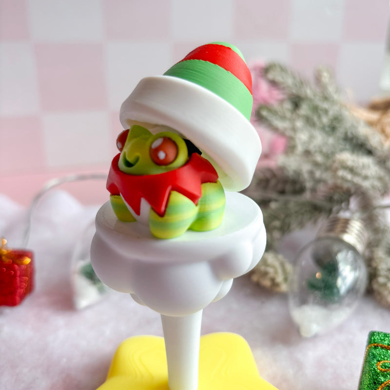 Colorful Christmas-themed figurine on a stand with a blurred decorative background