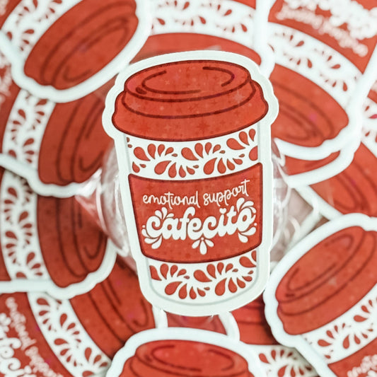 Sticker of a red coffee cup with 'emotional support cafecito' text on a red and white lace background.