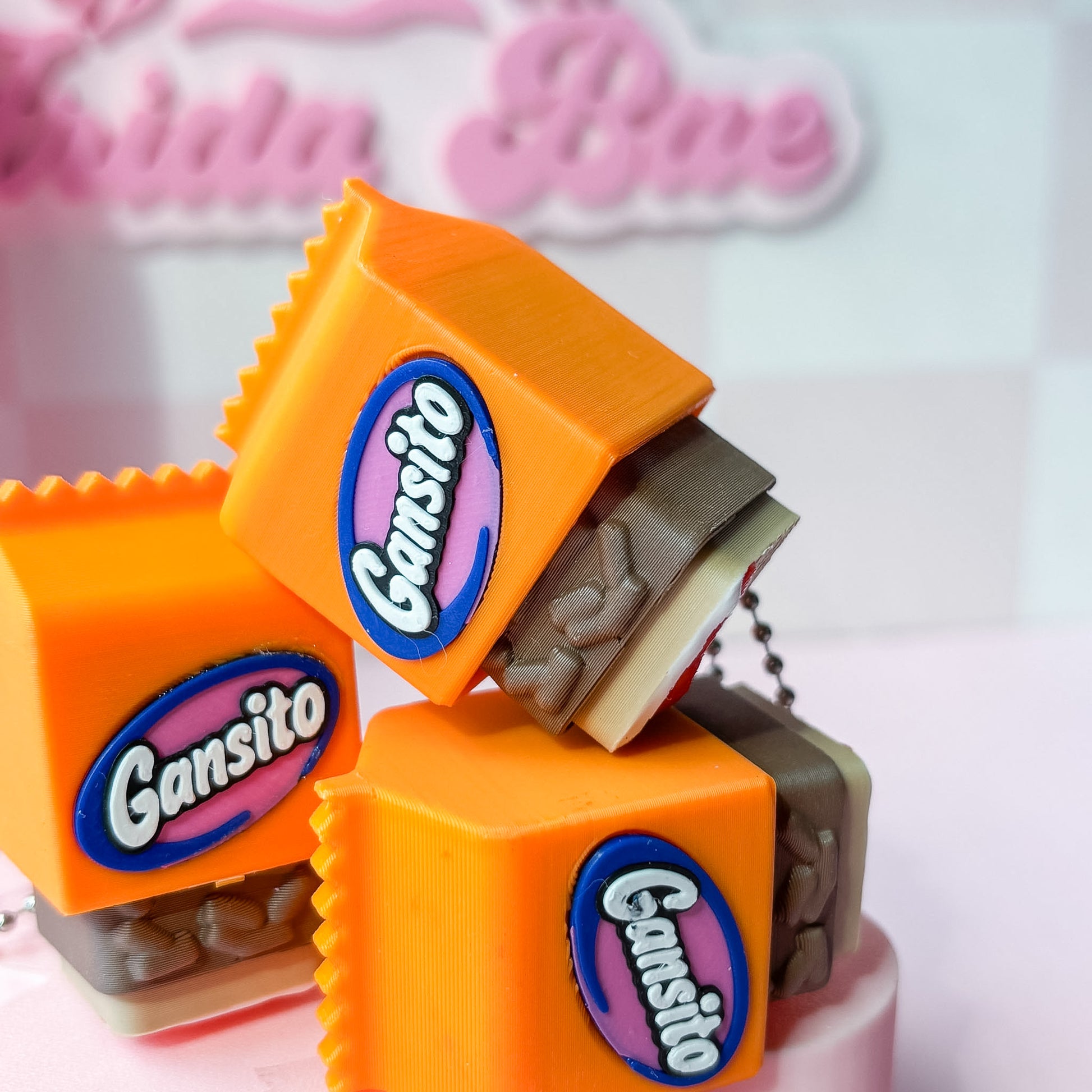 Gansito candy packaging figurines on a pink surface with 'Natalia Blue' text in the background