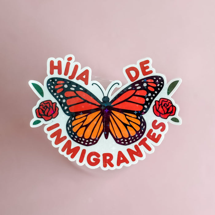 Sticker with butterfly and text 'Hija de Inmigrantes' on a pink background