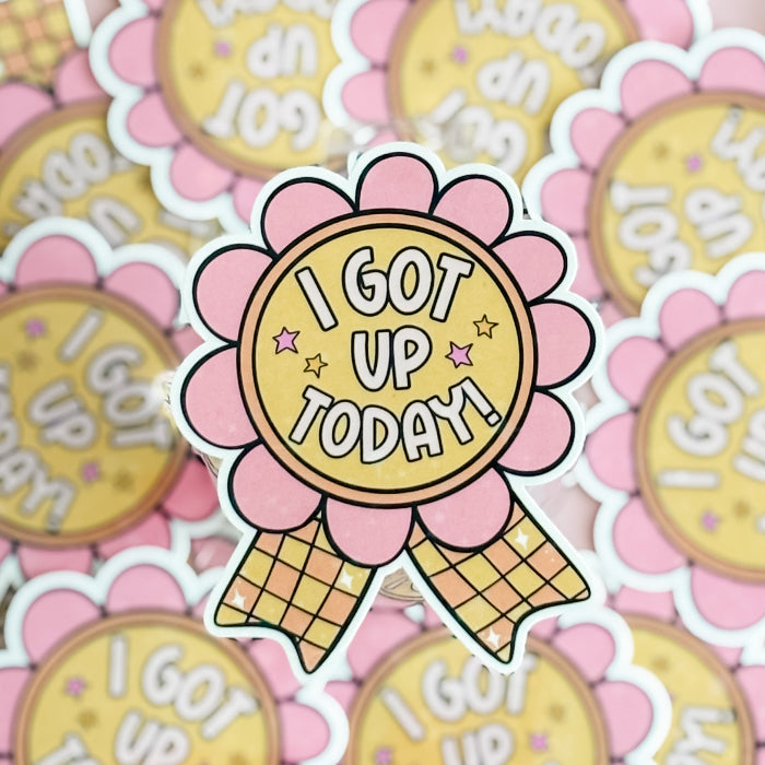 Sticker with 'I Got Up Today' text on a pink flower design