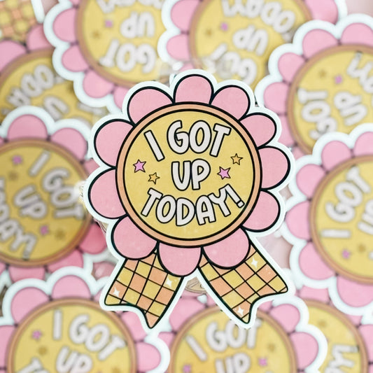Sticker with 'I Got Up Today' text on a pink flower design