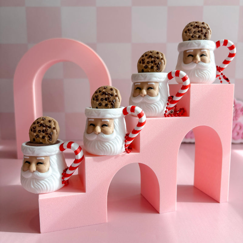 Santa Claus cookie jar fidget clicker with a cookie on top against a pink background