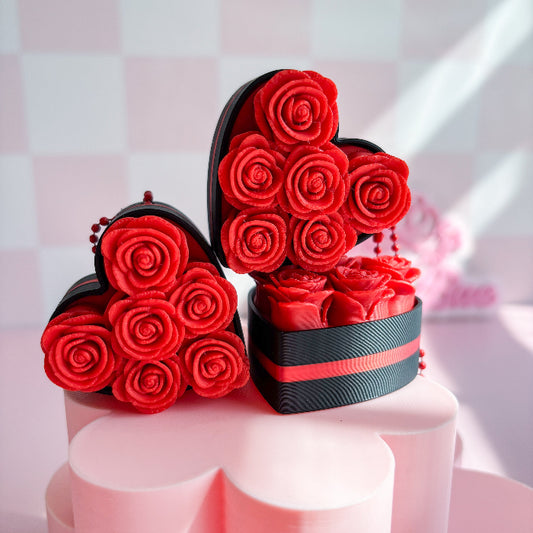 Heart-shaped boxes filled with red roses fidget clicker on a pink background
