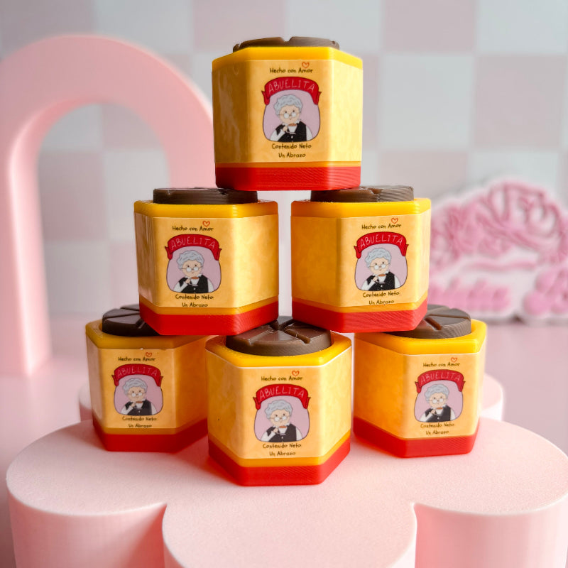 Stack of yellow and red tea canisters with a cartoon character on a pink stand.