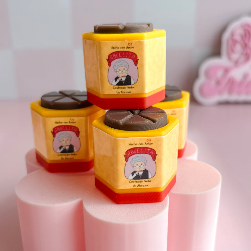 Stack of yellow and red containers with cartoon character label on a pink stand.