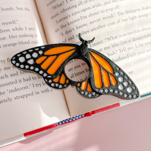 Butterfly-shaped book marker on an open book