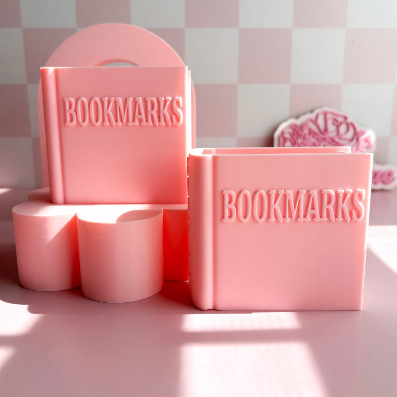 Pink containers labeled 'BOOKMARKS' on a checkered background