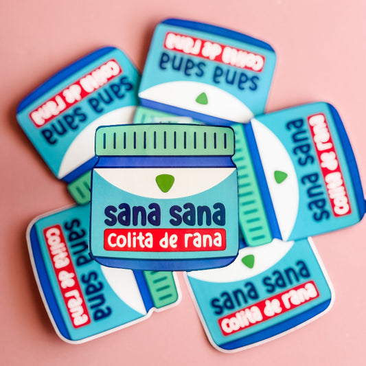 Sticker set with 'sana sana Colita de rana' design on a pink background
