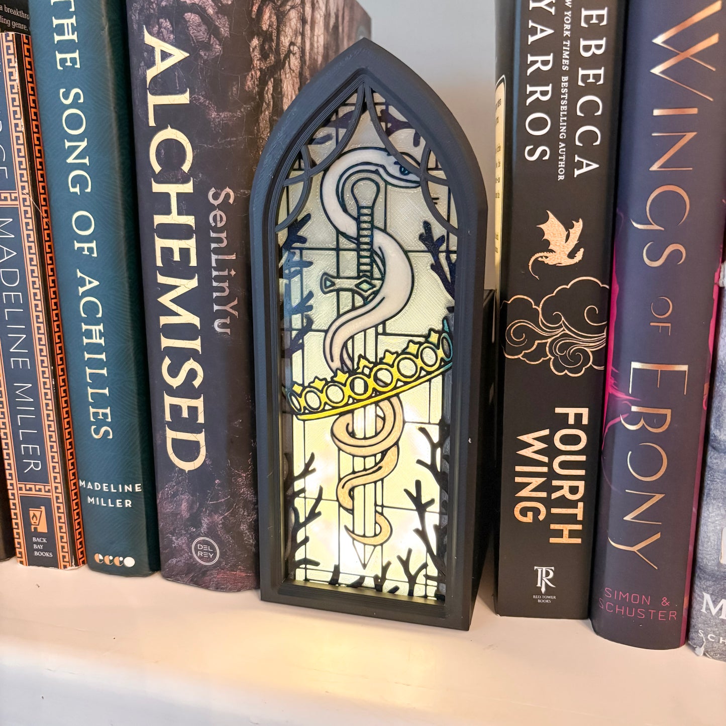 stained glass book holder with books on either side