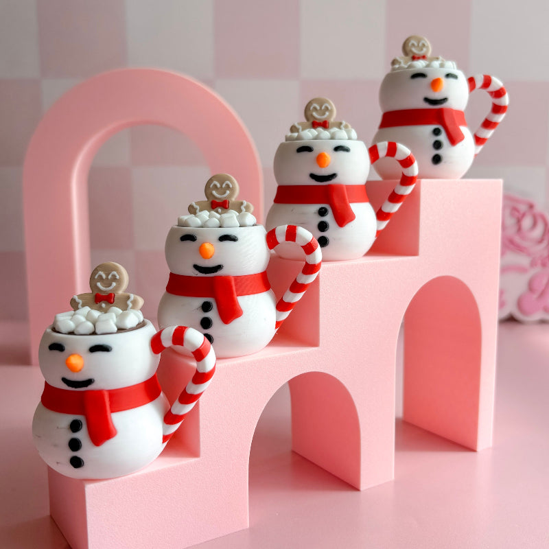 Decorative snowman figurines with candy canes on a pink arch