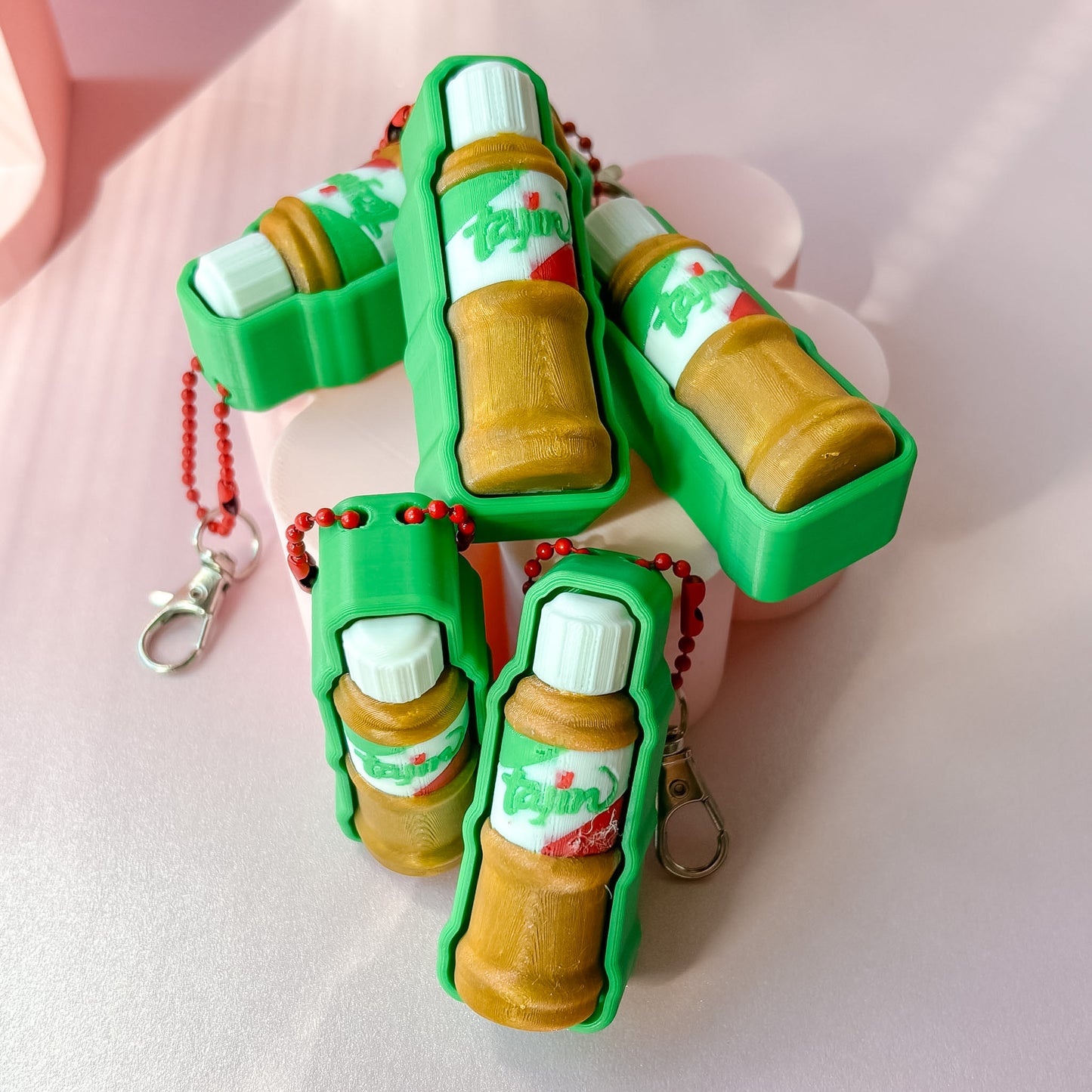 fidget clicker in the shape of tajin bottle green and caramel color