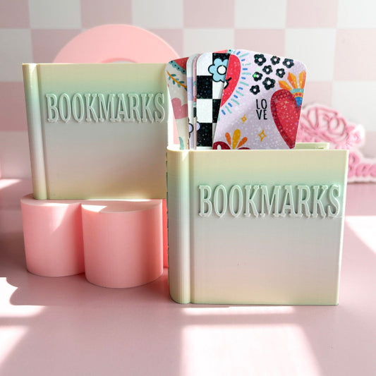 Bookmarks holder with colorful bookmarks on a pink background