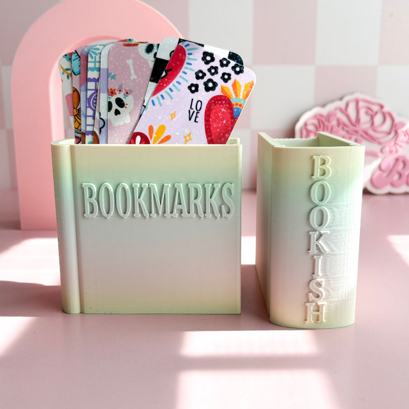 Two light green containers with 'BOOKMARKS' and 'BOOKISH' text on a pink background.