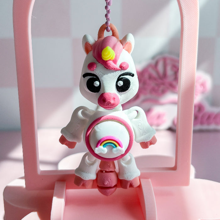 unicorn-shaped fidget toys on a pink background
