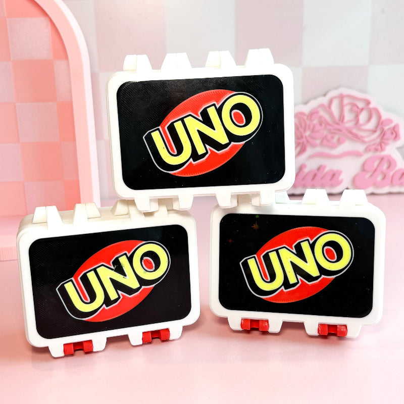 boxes with  UNO wording with pink backgound
